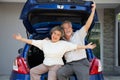 Happy Asian senior couple standing Ã¢â¬â¹back of the car and enjoying journey trip. Royalty Free Stock Photo